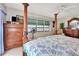 Main bedroom with a four-poster bed, dresser, and window seat at 731 Marina Point Dr # 7310, Daytona Beach, FL 32114