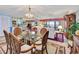 Dining room with a glass-top table, wooden chairs, and a chandelier at 731 Marina Point Dr # 7310, Daytona Beach, FL 32114