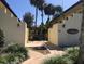Building entrance with a wrought iron gate and landscaping at 400 Oakridge Blvd # 6, Daytona Beach, FL 32118