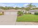 House exterior with a two-car garage and lush lawn at 1768 Creekwater Blvd, Port Orange, FL 32128