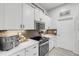 Modern kitchen with white cabinets, stainless steel appliances, and quartz countertops at 1768 Creekwater Blvd, Port Orange, FL 32128