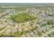 Aerial view of homes situated around a tranquil lake and wooded area at 1768 Creekwater Blvd, Port Orange, FL 32128