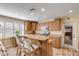 Bright kitchen featuring wood cabinets, stainless steel appliances, and breakfast bar at 501 S Peninsula Ave, New Smyrna Beach, FL 32169