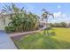 Landscaped side yard with walkway leading to home entrance at 501 S Peninsula Ave, New Smyrna Beach, FL 32169