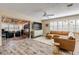 Spacious living room with L-shaped sectional sofa, large TV, and wood floors at 501 S Peninsula Ave, New Smyrna Beach, FL 32169