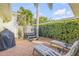 Private backyard oasis with hot tub, patio furniture, and lush landscaping at 501 S Peninsula Ave, New Smyrna Beach, FL 32169