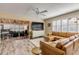 Bright living room with L-shaped sofa, access to sunroom, and wood floors at 501 S Peninsula Ave, New Smyrna Beach, FL 32169