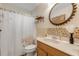 Bathroom with shower/tub combo, wood vanity, and tile at 501 S Peninsula Ave, New Smyrna Beach, FL 32169