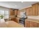 Updated kitchen with wood cabinets, stainless steel appliances, and granite countertops at 501 S Peninsula Ave, New Smyrna Beach, FL 32169