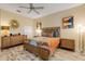 Well-lit bedroom with mid-century modern furniture and wood floors at 501 S Peninsula Ave, New Smyrna Beach, FL 32169