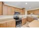 Eat-in kitchen with wood cabinets, stainless steel appliances, and granite countertops at 501 S Peninsula Ave, New Smyrna Beach, FL 32169