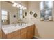 Clean bathroom with light wood cabinets and a large mirror at 501 S Peninsula Ave, New Smyrna Beach, FL 32169