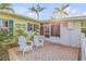 Relaxing patio area with two white adirondack chairs at 501 S Peninsula Ave, New Smyrna Beach, FL 32169
