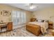 Bright bedroom with wood-look floors, large window with shutters, and built-in storage at 501 S Peninsula Ave, New Smyrna Beach, FL 32169