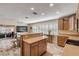 Open kitchen with island, wood cabinets and views to living room at 501 S Peninsula Ave, New Smyrna Beach, FL 32169