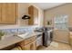 Laundry room with washer, dryer, cabinets, and a countertop at 501 S Peninsula Ave, New Smyrna Beach, FL 32169