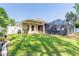 Landscaped backyard with a screened spa and grass at 5452 Saint Regis Way, Port Orange, FL 32128