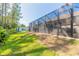 View of backyard with screened enclosure and lawn at 5452 Saint Regis Way, Port Orange, FL 32128