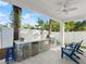 Outdoor kitchen with grill, refrigerator, and marble countertop at 224 Condict Dr, New Smyrna Beach, FL 32169