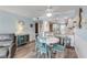 Charming dining area with white round table and teal chairs at 3801 S Atlantic Ave # 307, New Smyrna Beach, FL 32169