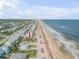 Aerial view of beachfront lot with ocean and neighborhood views at 6604 S Atlantic Ave, New Smyrna Beach, FL 32169