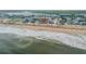 Aerial view of beachfront property, showcasing home and surrounding area at 6604 S Atlantic Ave, New Smyrna Beach, FL 32169