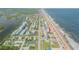 Aerial view of beach home near other houses at 6604 S Atlantic Ave, New Smyrna Beach, FL 32169