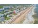 Beachfront home aerial view, near other homes at 6604 S Atlantic Ave, New Smyrna Beach, FL 32169