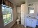 Bathroom with toilet, vanity, and linen cabinet at 689 Eagle Watch Rd, Oak Hill, FL 32759
