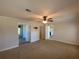 Large bedroom with ceiling fan and access to two bathrooms at 689 Eagle Watch Rd, Oak Hill, FL 32759