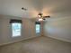 Well-lit bedroom with two windows and carpet flooring at 689 Eagle Watch Rd, Oak Hill, FL 32759