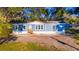 Newly built blue manufactured home on a spacious lot with mature trees at 689 Eagle Watch Rd, Oak Hill, FL 32759