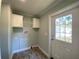 Practical laundry room with cabinets and exterior access at 689 Eagle Watch Rd, Oak Hill, FL 32759
