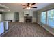 Spacious living room with wood-look floors and a stone fireplace at 689 Eagle Watch Rd, Oak Hill, FL 32759