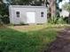 Tan storage building with double doors at 689 Eagle Watch Rd, Oak Hill, FL 32759