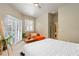 Bright bedroom with a king-size bed, sliding glass doors, and an en-suite bathroom at 69 S Turn Cir, Ponce Inlet, FL 32127