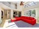 Two-story living room with red sectional sofa and view of kitchen at 69 S Turn Cir, Ponce Inlet, FL 32127