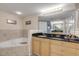 Spa-like bathroom with a corner tub, double vanity, and tiled flooring at 5300 S Atlantic Ave # 15-601, New Smyrna Beach, FL 32169
