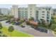 Multi-story condo building with parking and tropical landscaping at 5300 S Atlantic Ave # 15-601, New Smyrna Beach, FL 32169