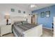 Cozy bedroom with a queen-size bed and calming blue walls at 5300 S Atlantic Ave # 15-601, New Smyrna Beach, FL 32169