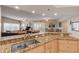 Kitchen features granite countertops and a double sink overlooking living room at 5300 S Atlantic Ave # 15-601, New Smyrna Beach, FL 32169
