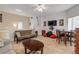 Open living space with futon, dining table, and TV at 5300 S Atlantic Ave # 15-601, New Smyrna Beach, FL 32169
