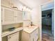 Well-lit bathroom with vanity, toilet, and cabinet at 3606 S Peninsula Dr # 614, Port Orange, FL 32127