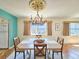 Charming dining room with water views and a unique chandelier at 3606 S Peninsula Dr # 614, Port Orange, FL 32127