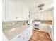 Updated kitchen featuring white cabinets and granite countertops at 3606 S Peninsula Dr # 614, Port Orange, FL 32127