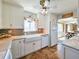 Modern kitchen boasts white cabinets, granite counters & a farmhouse sink at 3606 S Peninsula Dr # 614, Port Orange, FL 32127