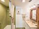 Clean bathroom with green tile, a shower/tub combo, and wicker mirror at 3606 S Peninsula Dr # 614, Port Orange, FL 32127