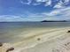 Serene sandy beach offering tranquil waterfront views at 113 Neptune Dr, Edgewater, FL 32132