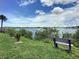 Scenic waterfront view with park bench and lush greenery at 113 Neptune Dr, Edgewater, FL 32132