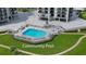 Inviting community pool with surrounding patio furniture at 501 N Causeway # 2050, New Smyrna Beach, FL 32169